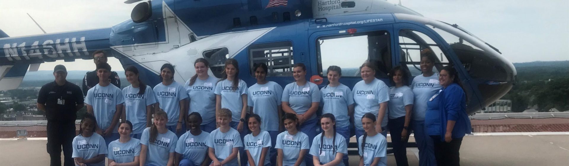 EINP HH Lifestar2 Students from the EINP program standing in front of a blue helicopter